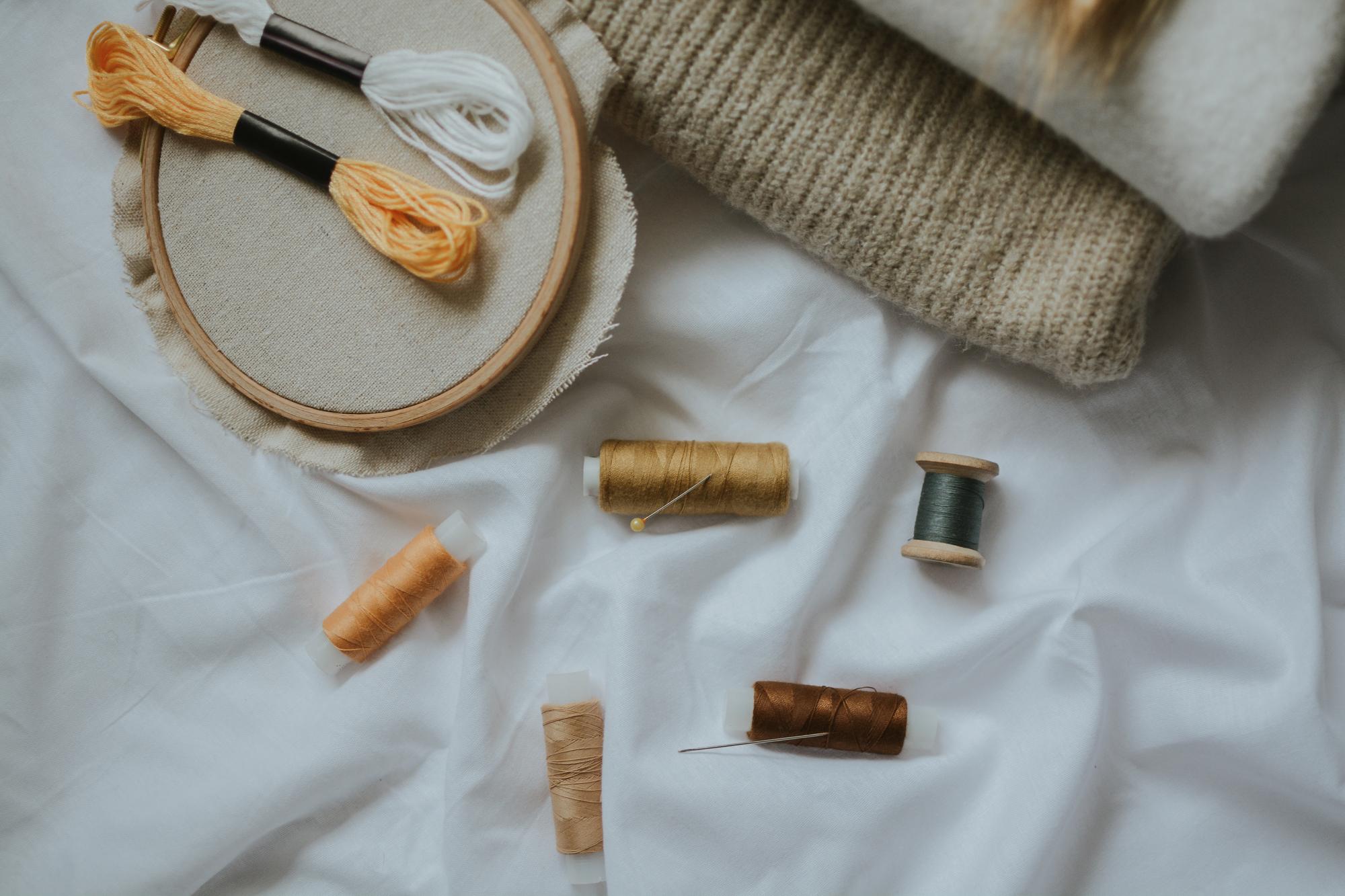 Workshop table with embroidered textiles and tools